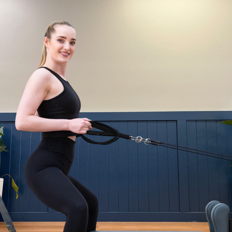 Woman on a Reformer during an on-demand Pilates class in Wagga Wagga